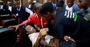 Police officers detain Sahara Reporters journalist Victor Ogungbenro during a protest in Lagos, Nigeria, on August 5, 2019. Staff at the online newspaper report sustained harassment targeting them and their website. Credit: CPJ/AP/Sunday Alamba.
