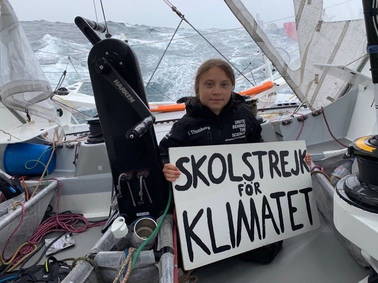 A publicity photo of Greta Thunberg on her way to New York aboard the yacht Malizia II in August 2019. The phrase ‘skolstrejk för klimatet’ means school strike for climate. EPA