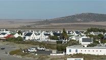 The view looking east across the West Coast with the village of Paternoster in the foreground. The recently approved Boulders Wind farm will stand on the hills in the background, directly in this view. Photo: John Yeld