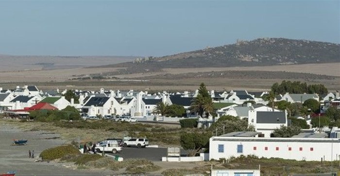 The view looking east across the West Coast with the village of Paternoster in the foreground. The recently approved Boulders Wind farm will stand on the hills in the background, directly in this view. Photo: John Yeld