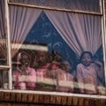 Children at window of a building in Hillbrow, Johannesburg. Children will be vulnerable if vaccinations are postponed. Photo by Marco Longari/AFP via Getty Images