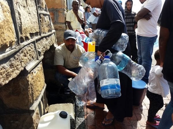 Capetonians stand in line to collect water at a natural spring during the water shortages. Photo: Steve Kretzmann