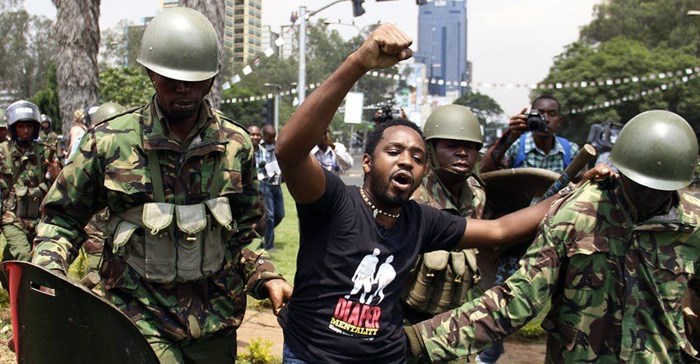Kenyan activist Boniface Mwangi is arrested during a protest in Nairobi in 2014. AFP via Getty Images.