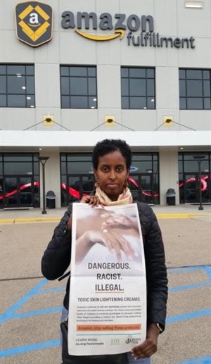 Amira Adawe, an activist with The Beautywell Project pickets outside Amazon. Amira Adawe