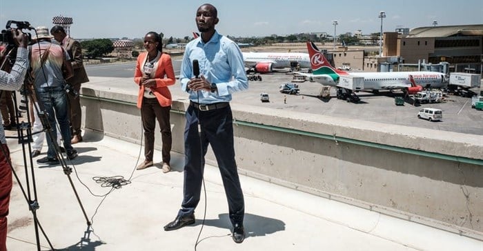 TV reporters prepare for a live broadcast during a strike by airline workers in Nairobi. Yasuyoshi Chiba/AFP via Getty Images.