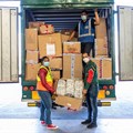 Siphokazi Mngxali (Woolworths national distribution service manager) and Ali Sablay (Gift of the Givers) loading up the truck with the help of Nur Davids (Woolworths).
