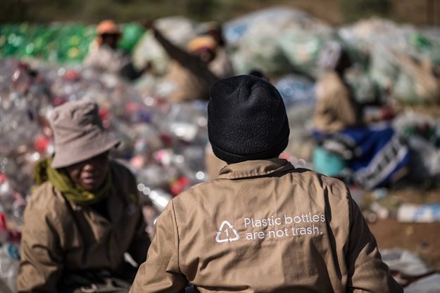 Two reclaimers help sort PET plastic bottles for recycling. A pilot programme in Joburg has helped solidify the reclaimer-resident relationship and empowered residents to recycle at home. (Image: Supplied)