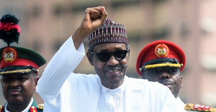 President Muhammadu Buhari raises his fist during an inspection of honour guards on parade to mark Democracy Day in Abuja, on June 12, 2019.<p>Pius Utomi Ekpei/AFP via Getty Images