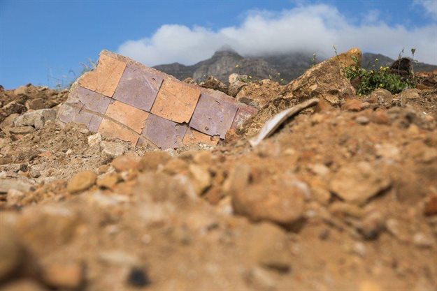 Tiles from homes previously demolished by the apartheid regime lie in the rubble. Photos by Ashraf Hendricks.