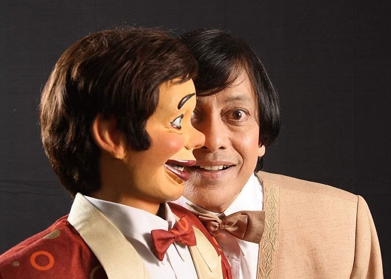 A ventriloquist and his puppet