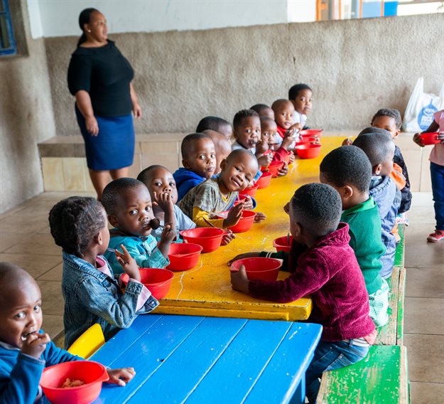 Young children enjoying a healthy snack at their ECD Centre in a KZN community.