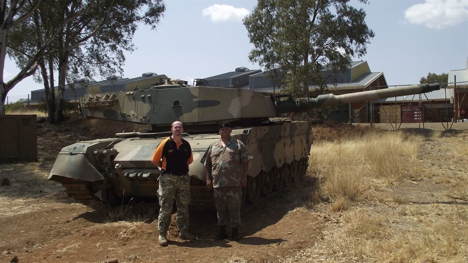Dr Dewald Venter with the Chair of the SA Armour Museum Lt Col R Erasmus. In the background is a South African Olifant Mk1B Main Battle Tank
