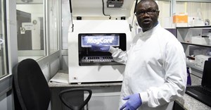 Professor Christian Happi, director of the African Centre of Excellence for Genomics of Infectious Diseases, displays one of the most advanced automated acid extractors being used in the laboratory. Pius Utomi Ekpei/AFP via Getty Images