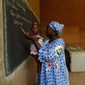 A teacher holds a child as young women learn business skills at Centre D'Apprentissage Feminin (C.A.FE.) in Bamako, Mali, Africa in June 2018. The school is funded by the Canadian NGO Education internationale, a co-operative offering exchange and development services in education. THE CANADIAN PRESS/ Sean Kilpatrick