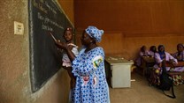 A teacher holds a child as young women learn business skills at Centre D'Apprentissage Feminin (C.A.FE.) in Bamako, Mali, Africa in June 2018. The school is funded by the Canadian NGO Education internationale, a co-operative offering exchange and development services in education. THE CANADIAN PRESS/ Sean Kilpatrick