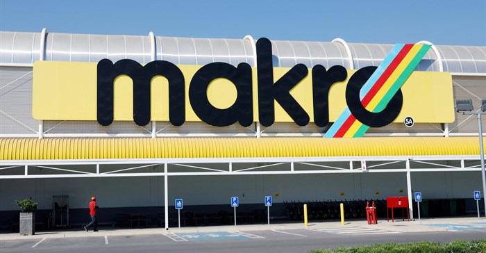 A worker walks beneath a logo at Makro Store Riversands of South African retailer Massmart in Midrand, South Africa, August 28, 2019. Reuters/Siphiwe Sibeko/File Photo