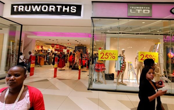Shoppers walk past a Truworths shop with advertisements on its windows at the Sandton shopping mall in Johannesburg, file. Reuters/Siphiwe Sibeko/File Photo