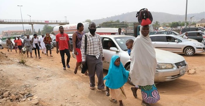 People walking next to traffic in Abuja, Nigeria’s capital city.<p>Photo by Kola Sulaimon/AFP via Getty Images
