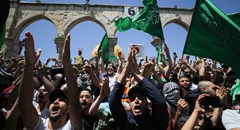 People hold Hamas flags as Palestinians gather after performing the last Friday of Ramadan to protest over the possible eviction of several Palestinian families from homes on land claimed by Jewish settlers in the Sheikh Jarrah neighbourhood, in Jerusalem's Old City, May 7, 2021. Reuters/Ammar Awad