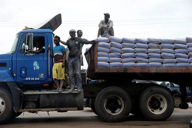 Labourers stand on top of a trailer transporting cement along Ajah-Lagos expressway in Nigeria's commercial capital Lagos, Nigeria. Reuters/Akintunde Akinleye
