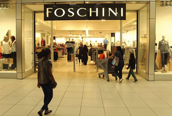 A shopper walks past a Foschini store at a shopping centre in Lenasia, south of Johannesburg, August 28, 2013. Reuters/Siphiwe Sibeko