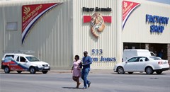 A couple leaves Tiger Brands factory shop in Germiston, Johannesburg, South Africa, 5 March 2018. Reuters/Siphiwe Sibeko
