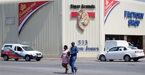 A couple leaves Tiger Brands factory shop in Germiston, Johannesburg, South Africa, 5 March 2018. Reuters/Siphiwe Sibeko