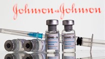 Vials labelled &quot;Covid-19 coronavirus vaccine&quot; and syringe are seen in front of displayed Johnson & Johnson logo in this illustration taken, February 9, 2021. Reuters/Dado Ruvic/File Photo