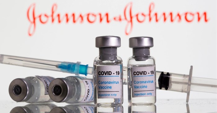 Vials labelled &quot;Covid-19 coronavirus vaccine&quot; and syringe are seen in front of displayed Johnson & Johnson logo in this illustration taken, February 9, 2021. Reuters/Dado Ruvic/File Photo