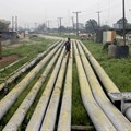 A woman walks over pipelines crisscrossing Ogoniland in Rivers State, Nigeria September 18, 2020. Reuters/Afolabi Sotunde//File Photo