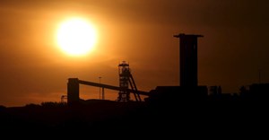 The sun sets behind a shaft outside the mining town of Carletonville, west of Johannesburg, file. Reuters/Siphiwe Sibeko