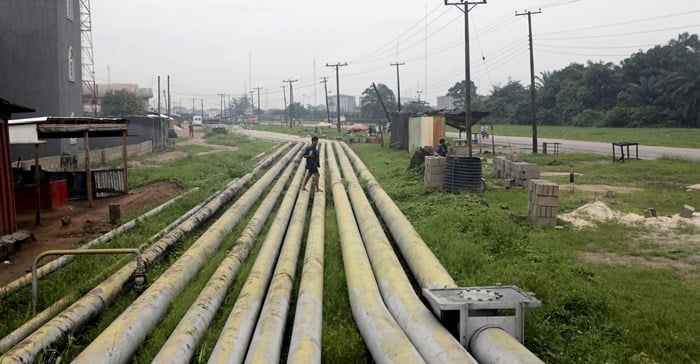 A woman walks over pipelines crisscrossing Ogoniland in Rivers State, Nigeria 18 September, 2020. Reuters/Afolabi Sotunde//File Photo