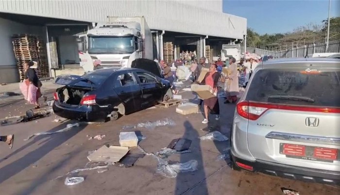Demonstrators loot the Ayoba Cold Store as protests continue, following imprisonment of former South Africa President Jacob Zuma, in Chesterville, Durban, KwaZulu-Natal, South Africa 12 July 2021, in this still image obtained from social media video. Siphiwe Emacous Moyo Snr/via Reuters