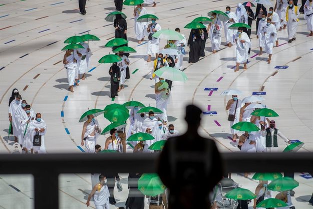 Saudi police officer stands guard as pilgrims arrive to perform their final Tawaf in the Grand Mosque, in the holy city of Mecca, Saudi Arabia, 20 July 2021. Saudi Ministry of Media/Handout via Reuters