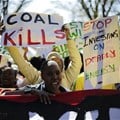 Demonstrators in Johannesburg march against environmental damage done by coal. Photo by Cornell Tukiri/Anadolu Agency/Getty Images