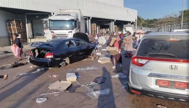 Demonstrators loot the Ayoba Cold Store in Chesterville, Durban, KwaZulu-Natal, 12 July 2021, in this still image obtained from social media video. Siphiwe Emacous Moyo Snr/via Reuters