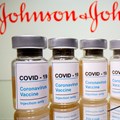 Vials with a sticker reading, &quot;COVID-19 / Coronavirus vaccine / Injection only&quot; and a medical syringe are seen in front of a displayed Johnson & Johnson logo in this illustration taken 31 October 31, 2020. Reuters/Dado Ruvic/File Photo