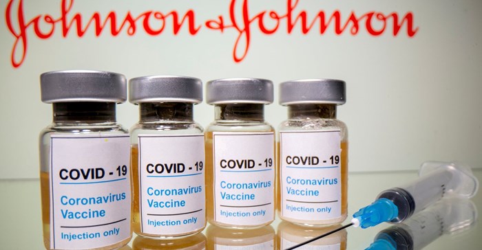 Vials with a sticker reading, &quot;COVID-19 / Coronavirus vaccine / Injection only&quot; and a medical syringe are seen in front of a displayed Johnson & Johnson logo in this illustration taken 31 October 31, 2020. Reuters/Dado Ruvic/File Photo
