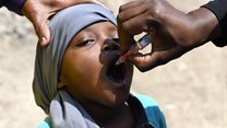 A child gets a dose of the oral polio vaccine. Simon Maina/AFP via Getty Images