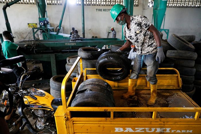A worker offloads used car tyres from a cargo tricycle in preparation for recycling at the Freetown waste management recycle factory in Ibadan, Nigeria September 17, 2021. | Source: Reuters/Temilade Adelaja