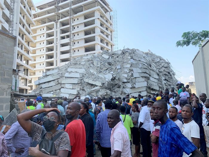 People gather at the site of a collapsed 21-storey building in Ikoyi, Lagos, Nigeria, 1 November 2021. Reuters/Temilade Adelaja