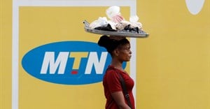 A woman walks past an advertising posters for MTN telecommunication company along a street in Lagos, Nigeria 28 August 2019. Reuters/Temilade Adelaja