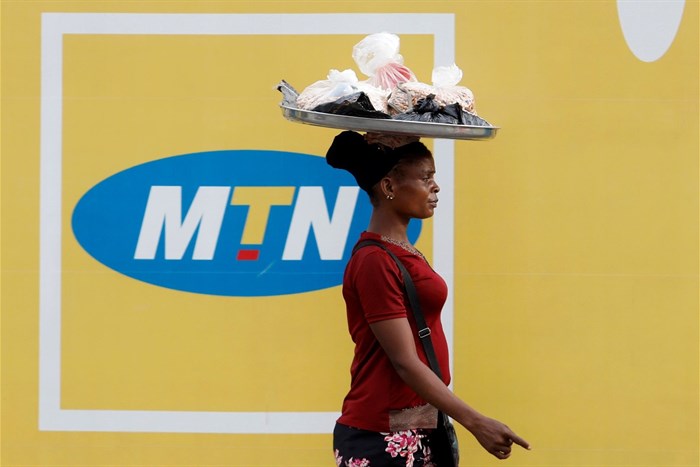 A woman walks past an advertising posters for MTN telecommunication company along a street in Lagos, Nigeria 28 August 2019. Reuters/Temilade Adelaja