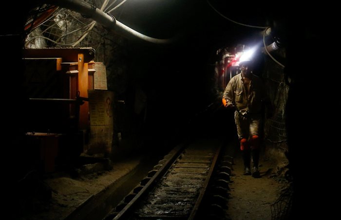Mine security officials walk underground at Sibanye Gold's Masimthembe mine in Westonaria. Reuters/Mike Hutchings