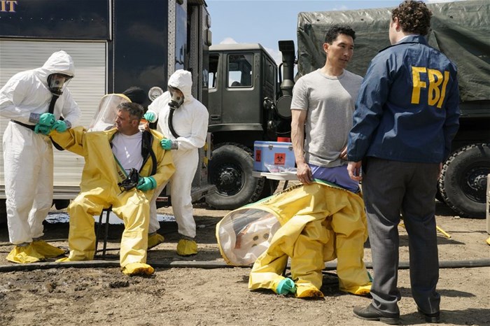 FBI Special Agent Matthew Ryker (Daniel Dae Kim) talks with Agent Moore (Ian Colletti) as he removes his HAZMAT suit after exiting the Pentagon