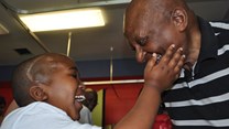 Source:  Lorenzo Jansen, who lost his sight when he had TB meningitis, touches Archbishop Desmond Tutu’s face in one of the paediatric wards at Tygerberg Hospital in Cape Town. Photo: Kim Cloete