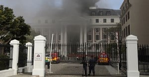 Firefighters work among the smoke after a fire broke out in the Parliament in Cape Town, South Africa. Reuters/Sumaya Hisham
