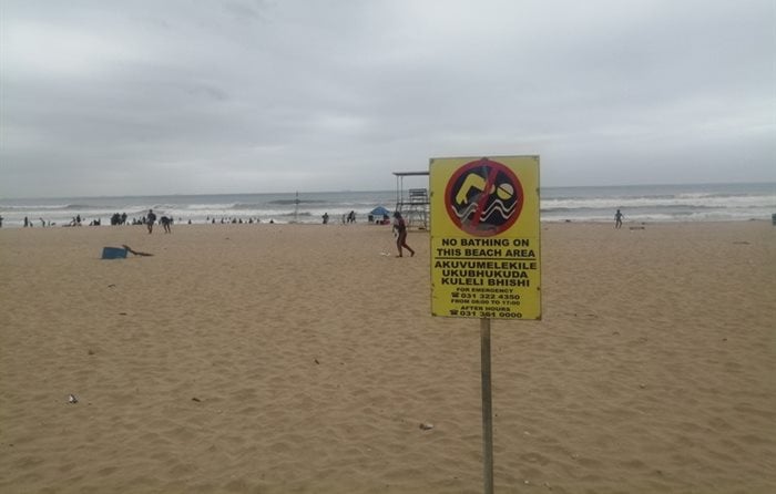 On Wednesday beach users swam at Durban’s South Beach despite signs warning the public that the ocean was polluted as a result of a recent sewage spill. | Photo: Nokulunga Majola