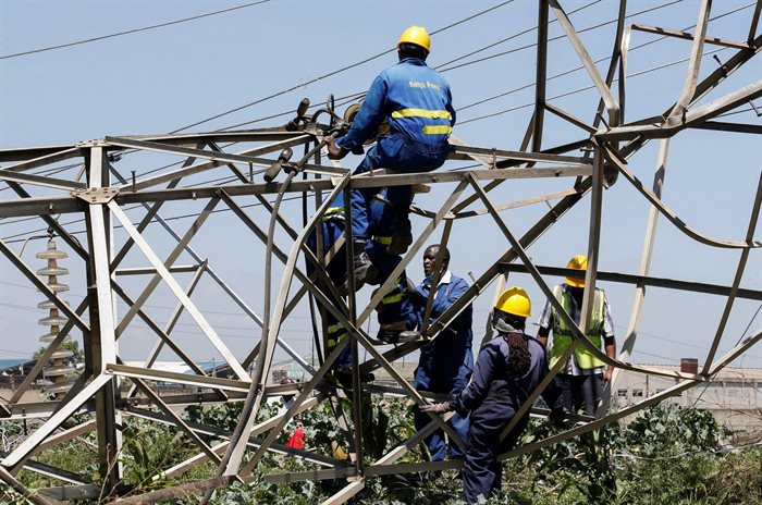 Technicians work on collapsed high voltage electricity transmission pylons from the Kiambere hydroelectric dam in Embakasi district of Nairobi, Kenya, 12 January 2022. Reuters/Monicah Mwangi