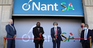 Source: REUTERS/Shelley Christians. Cyril Ramaphosa and Dr. Patrick Soon-Shiong cut a ribbon, while Premier of the Western Cape Alan Winde looks on.